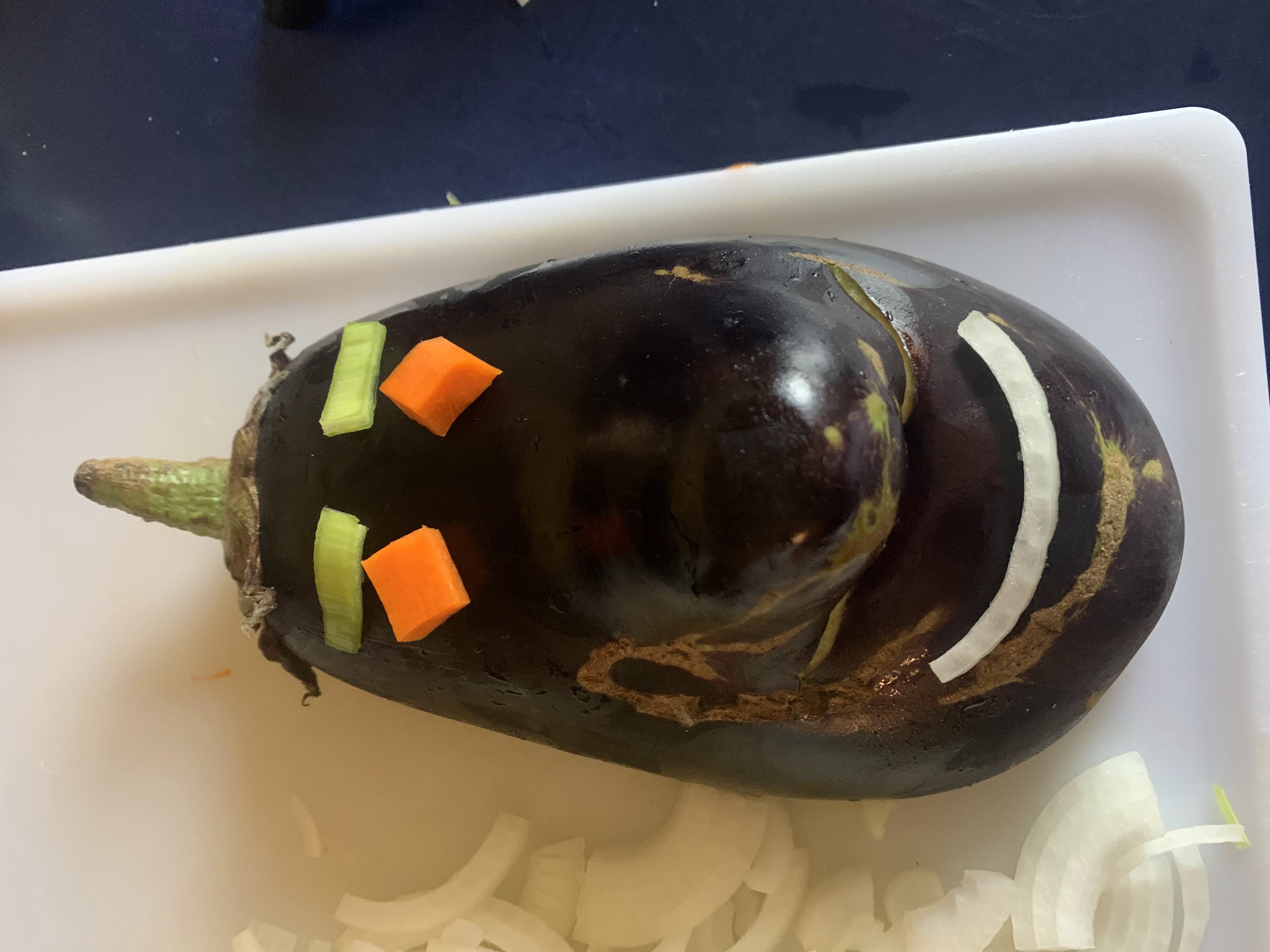 eggplant with vegetables on it to look like it smiles